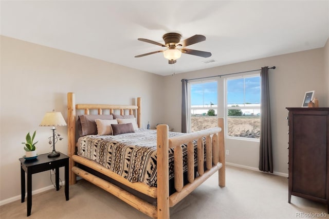 bedroom with visible vents, ceiling fan, light carpet, and baseboards