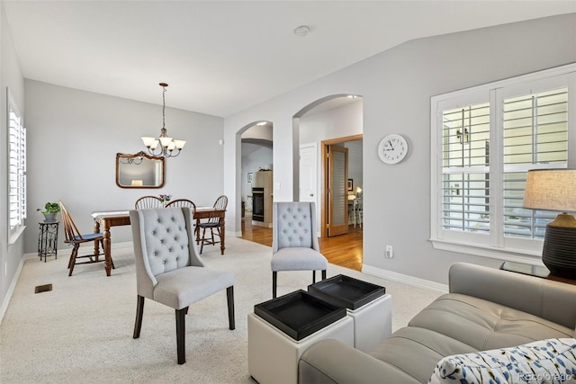 829 Sanctuary Cir, Longmont, CO 80504 - living room with arched walkways, plenty of natural light, and light colored carpet