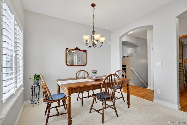 829 Sanctuary Cir, Longmont, CO 80504 - dining space featuring arched walkways and a chandelier