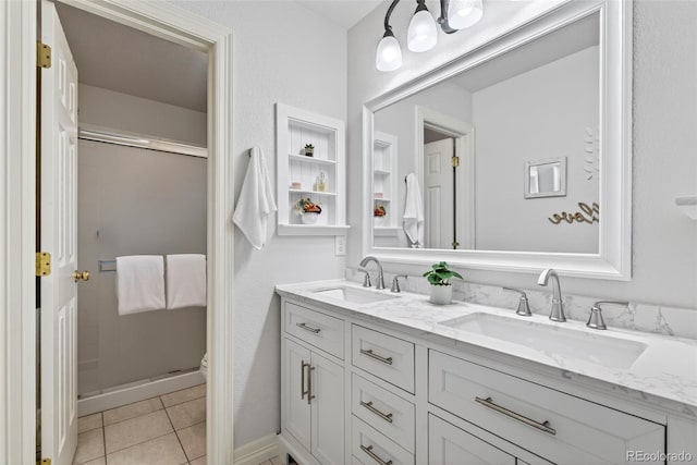 829 Sanctuary Cir, Longmont, CO 80504 - full bath with double vanity, a shower stall, and tile patterned flooring