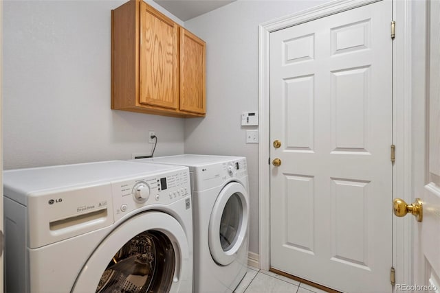 829 Sanctuary Cir, Longmont, CO 80504 - laundry area featuring washing machine and clothes dryer, cabinet space, and light tile patterned floors