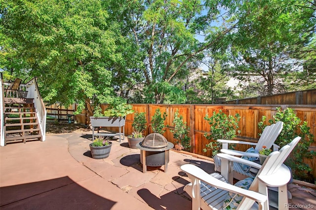 829 Sanctuary Cir, Longmont, CO 80504 - fenced backyard with a fire pit, a patio area, and stairway