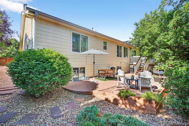 829 Sanctuary Cir, Longmont, CO 80504 - back of property with a deck, a patio area, and stairway