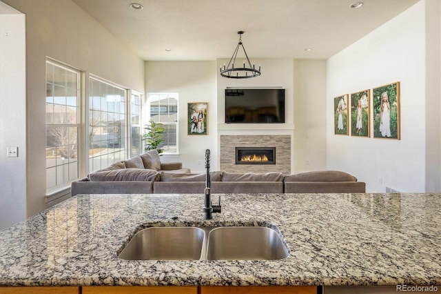 kitchen with light stone countertops and sink