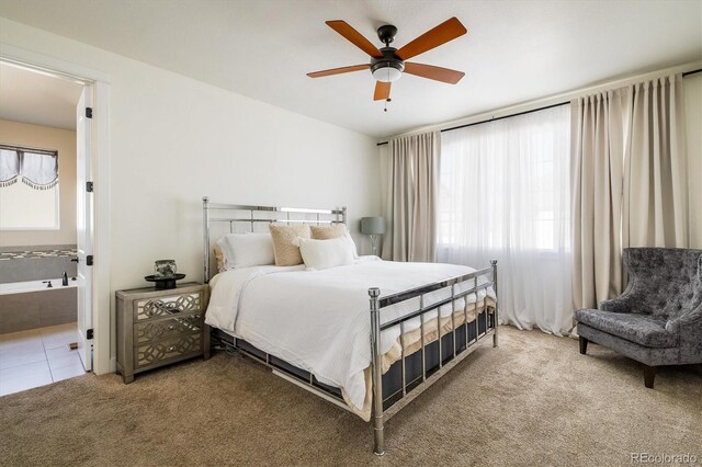 carpeted bedroom featuring connected bathroom and ceiling fan