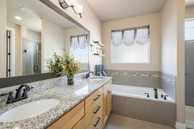 bathroom featuring tile patterned flooring, plenty of natural light, and independent shower and bath