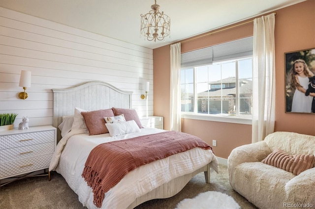 bedroom featuring a chandelier and carpet