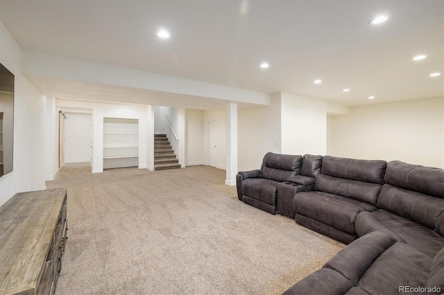 living room with built in shelves and light colored carpet