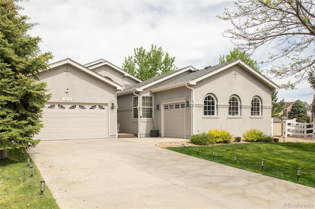 1510 S De Gaulle Cir, Aurora, CO 80018 - single story home featuring an attached garage, driveway, stucco siding, and a front yard