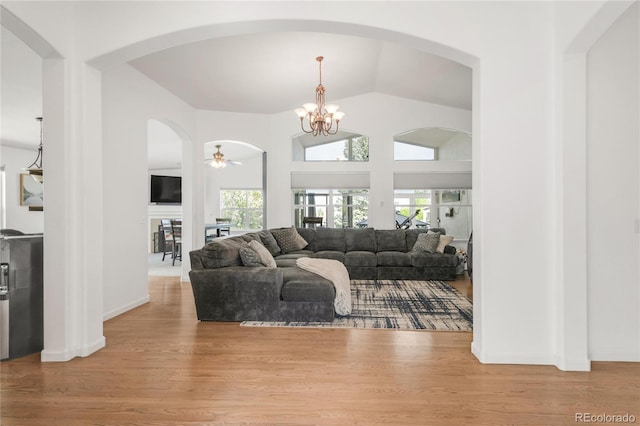 1510 S De Gaulle Cir, Aurora, CO 80018 - living area with wood finished floors, a chandelier, vaulted ceiling, arched walkways, and ceiling fan