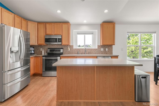 1510 S De Gaulle Cir, Aurora, CO 80018 - kitchen featuring appliances with stainless steel finishes, a sink, decorative backsplash, light countertops, and recessed lighting