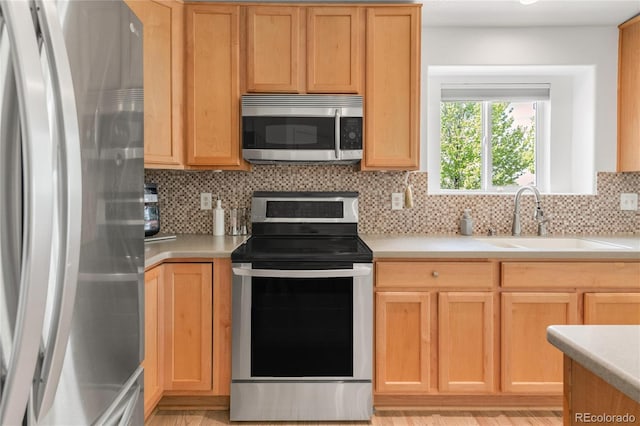 1510 S De Gaulle Cir, Aurora, CO 80018 - kitchen featuring stainless steel appliances, a sink, tasteful backsplash, and light countertops