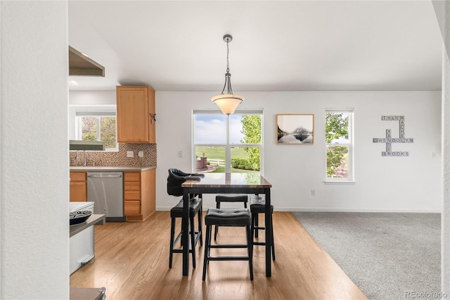 1510 S De Gaulle Cir, Aurora, CO 80018 - dining room with plenty of natural light, light wood-style flooring, and baseboards