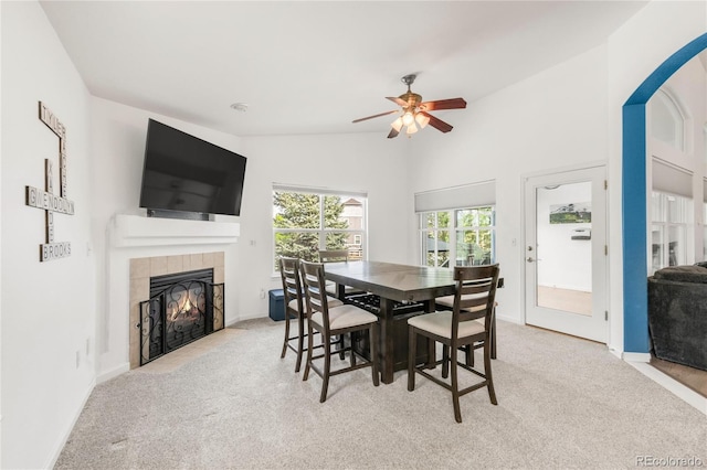 1510 S De Gaulle Cir, Aurora, CO 80018 - dining area featuring carpet floors, a tile fireplace, ceiling fan, and baseboards