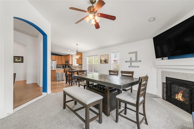 1510 S De Gaulle Cir, Aurora, CO 80018 - dining space featuring ceiling fan, a tile fireplace, light colored carpet, baseboards, and recessed lighting