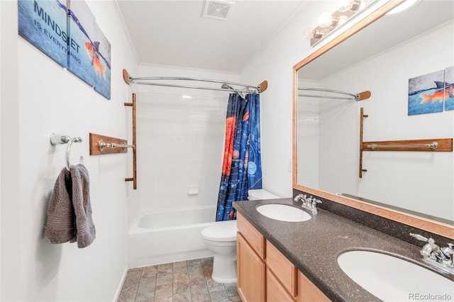 1510 S De Gaulle Cir, Aurora, CO 80018 - bathroom featuring shower / tub combo with curtain, toilet, double vanity, stone finish floors, and baseboards