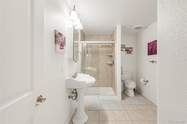 1510 S De Gaulle Cir, Aurora, CO 80018 - full bathroom with toilet, a shower stall, and tile patterned floors