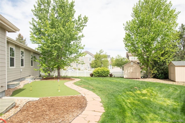 1510 S De Gaulle Cir, Aurora, CO 80018 - view of yard featuring a shed, an area to practice putting, and an outdoor structure