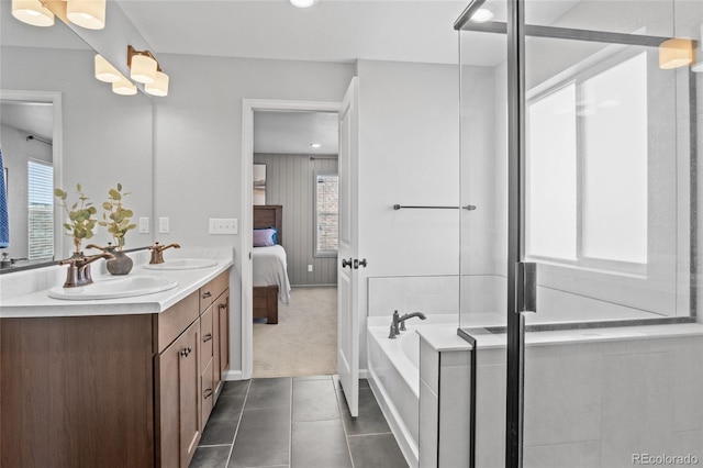 ensuite bathroom with double vanity, a bath, tile patterned flooring, an enclosed shower, and recessed lighting