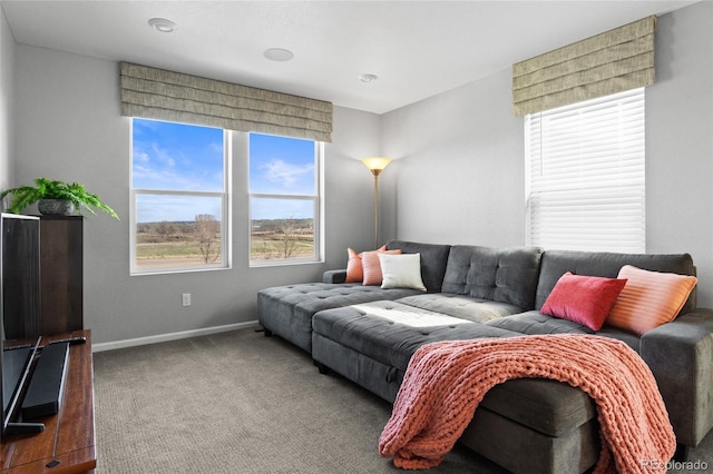 carpeted living room with baseboards
