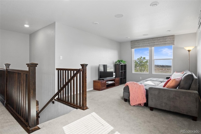 living area with light carpet and recessed lighting