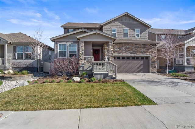 craftsman-style home featuring a garage, driveway, a front lawn, and stone siding