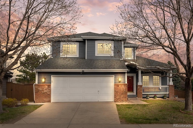 view of front of house with a garage, fence, driveway, and brick siding