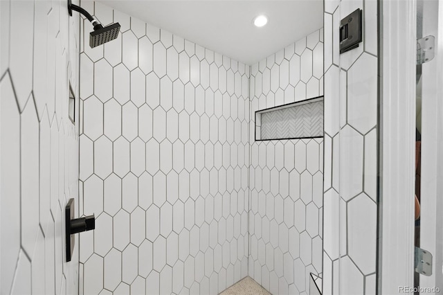 full bathroom with recessed lighting and tiled shower