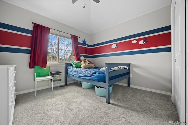 carpeted bedroom featuring baseboards and ceiling fan