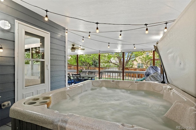 view of patio with fence, a hot tub, and area for grilling