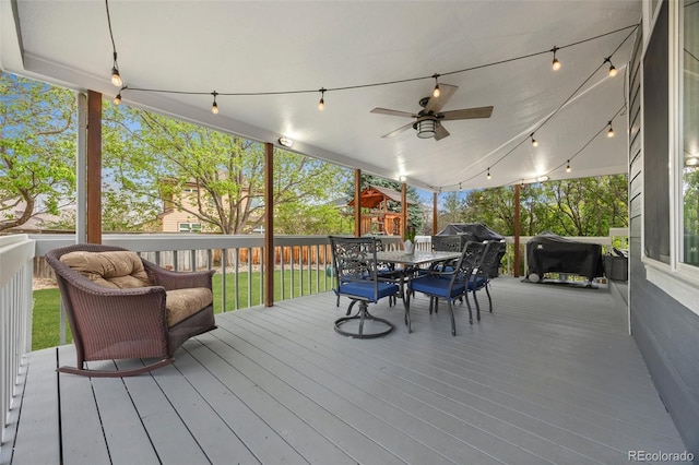 wooden terrace featuring ceiling fan, a grill, and outdoor dining space