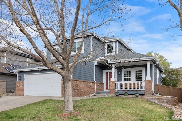 view of front facade with brick siding, a front lawn, driveway, and covered porch