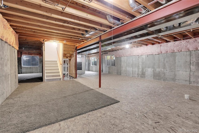 unfinished basement featuring stairs