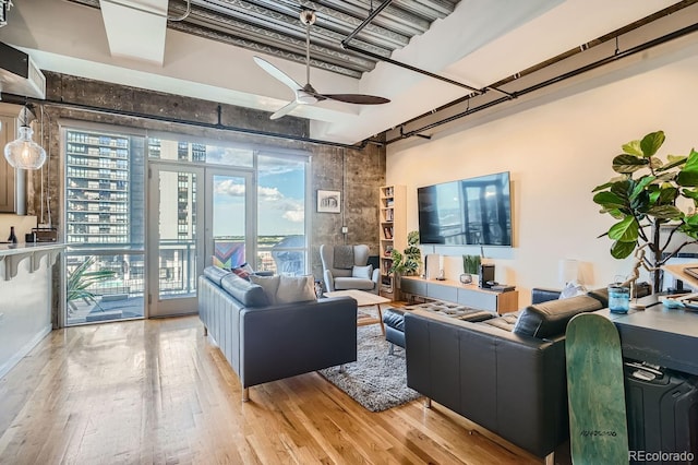 living room featuring ceiling fan and light wood-type flooring