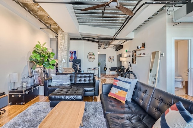 living room featuring hardwood / wood-style floors and ceiling fan