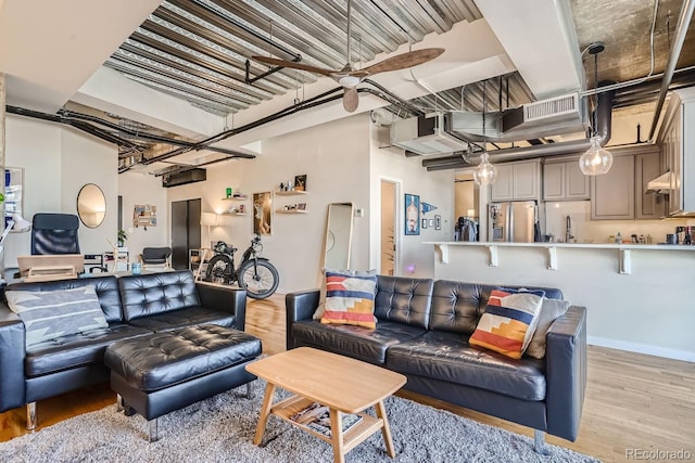 living room with light wood-type flooring and ceiling fan