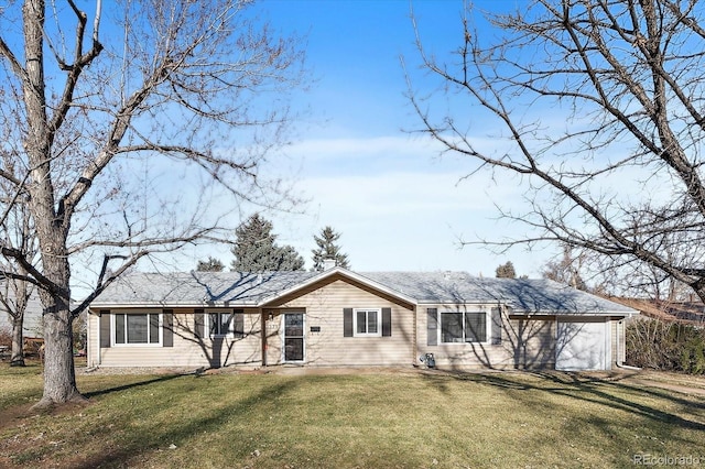 ranch-style house featuring a front yard and a garage