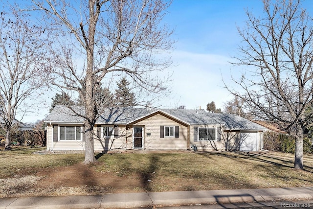 ranch-style house featuring a front lawn and a garage