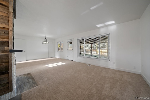 unfurnished living room featuring carpet flooring