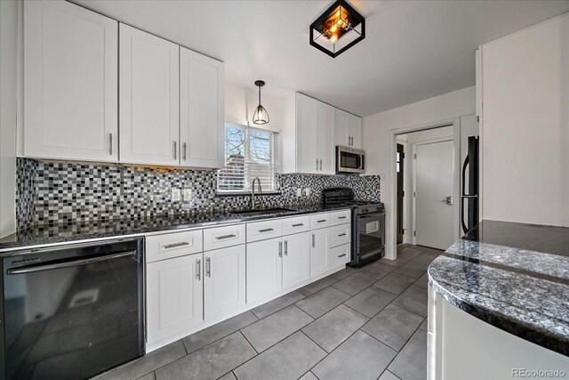 kitchen featuring white cabinetry, sink, hanging light fixtures, decorative backsplash, and black appliances