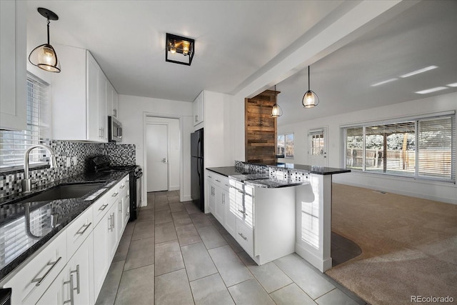 kitchen with white cabinets, sink, hanging light fixtures, and black appliances