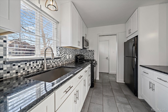 kitchen with sink, dark stone counters, decorative backsplash, white cabinets, and black appliances