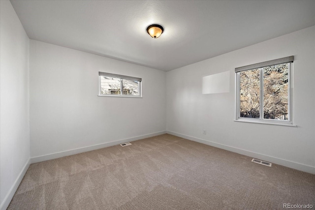 empty room with light colored carpet