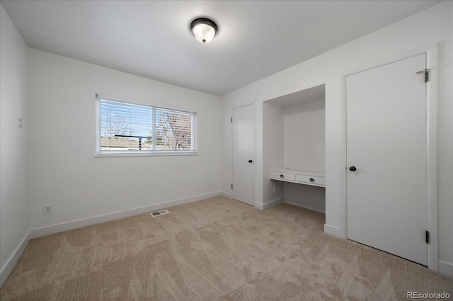 unfurnished bedroom with light colored carpet