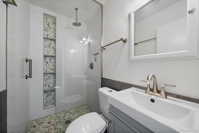 bathroom featuring vanity, toilet, and an enclosed shower