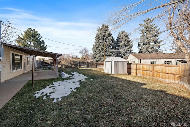 view of yard featuring a shed and a patio area