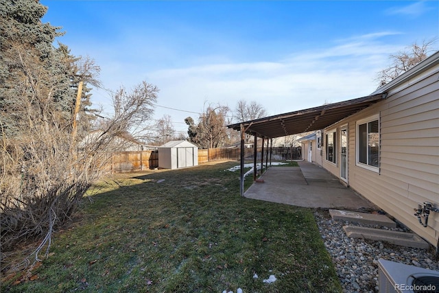 view of yard featuring a shed and a patio