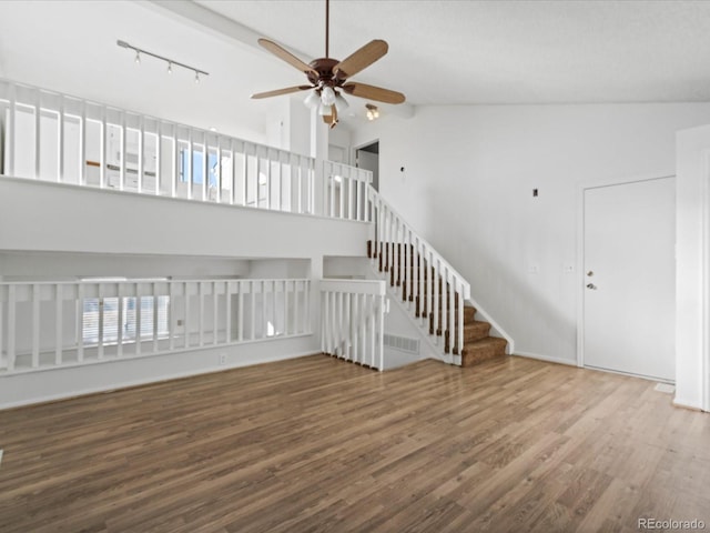 unfurnished living room with hardwood / wood-style flooring, ceiling fan, and high vaulted ceiling