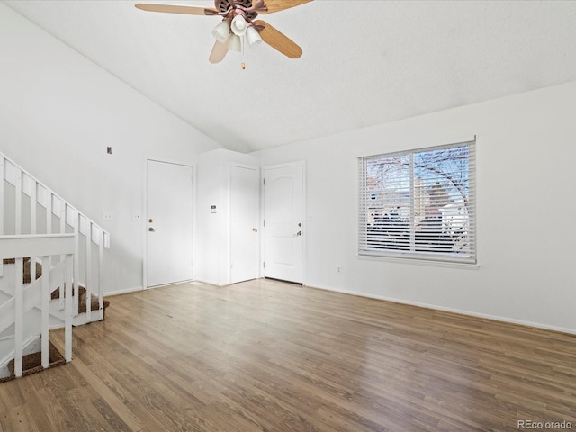 unfurnished living room with lofted ceiling, hardwood / wood-style floors, and ceiling fan