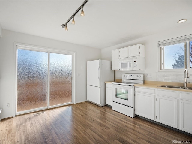 kitchen featuring dark hardwood / wood-style flooring, sink, white cabinets, and white appliances